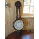 A 20TH CENTURY CARVED OAK ANEROID BAROMETER, H 79 cm