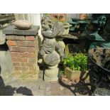 A LARGE GARDEN STONE STATUE DEPICTING A CHERUB PLAYING CYMBALS WHILST RESTING ON A STONE BALL, H