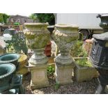 A PAIR OF STONE FLORAL GARDEN URNS RAISED ON SQUARED PLINTHS, H 106 cm (2)
