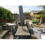 A GARDEN CAST AND WOODEN TABLE WITH FOUR GARDEN CHAIRS AND A PARASOL