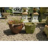 A TERRACOTTA STYLE GARDEN URN AND A SQUARE BRICK EFFECT URN (2)