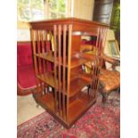 AN EDWARDIAN MAHOGANY REVOLVING BOOKCASE WITH SATINWOOD INLAID DETAIL