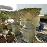 A PAIR OF GARDEN STONE URNS ON SQUARED PLINTHS, Overall H 82 cm (2)