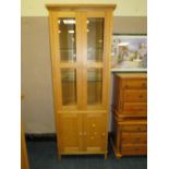 A MODERN LIGHT OAK GLAZED BOOKCASE H-191 W-72 CM