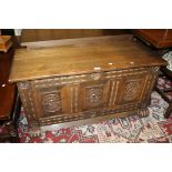 A 20TH CENTURY CARVED OAK COFFER W-109 CM