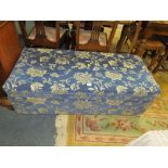 A MODERN BLUE UPHOLSTERED OTTOMAN