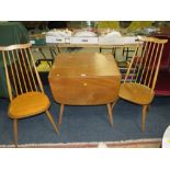 A BLONDE ERCOL DROPLEAF TABLE WITH TWO STICKBACK CHAIRS