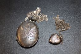 TWO VINTAGE ENGRAVED SILVER LOCKETS AND CHAINS