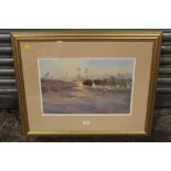 A FRAMED AND GLAZED WATERCOLOUR OF A DESSERT CAMEL TRAIN BY TREVOUR WAUGH ENTITLED CARAVAN'S AT