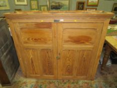 A VINTAGE PINE TWO DOOR BOOKCASE WITH PLAQUE 'ADDISION LTD, WELLINGTON SALOP' H-122 W-138 D-38 CM