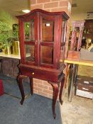 A REPRODUCTION GLAZED CABINET IN STAND - H 135 CM, W 61 CM