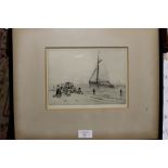 A FRAMED AND GLAZED ENGRAVING OF A DUTCH STYLE HARBOUR SCENE