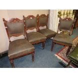 A SET OF FOUR EDWARDIAN CARVED MAHOGANY DINING CHAIRS