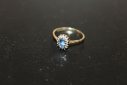 HALLMARKED 9CT GOLD RING SET WITH BLUE STONE AND SMALL DIAMONDS