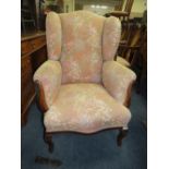 A VINTAGE UPHOLSTERED ARMCHAIR