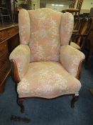 A VINTAGE UPHOLSTERED ARMCHAIR
