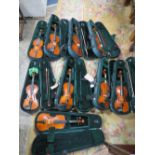 NINE ASSORTED VIOLINS IN GREEN CARRY CASES