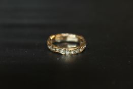 A 9CT DIAMOND SET ETERNITY RING - APPROX WEIGHT 2.2 G INCLUDING RING SPACER