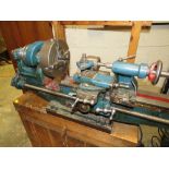 A MYFORD METALWORKING LATHE ON WOODEN PLINTH COMPLETE WITH FOUR JAW CHUCK AND ELECTRIC MOTOR 240V