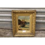 A SMALL GILT FRAMED OIL ON CANVAS OF A BEACHED SAIL SHIP WITH FRAMERS LABEL FROM DUNDEE VERSO