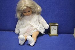 A CARRIAGE CLOCK AND A VINTAGE DOLL