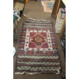 A VINTAGE HAND KNITTED TURKISH RUG WITH A UNUSUAL KLIM END PANELS