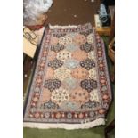 A VINTAGE HAND KNITTED TURKISH RUG