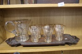A SET OF DRINKING GLASSES AND A WOODEN TRAY