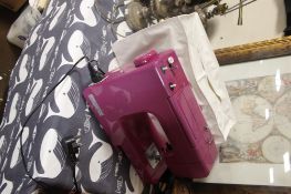 A JOHN LEWIS SEWING MACHINE IN PINK