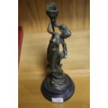 A BRONZE TYPE FIGURE OF A CANDLE STICK