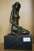 A BRONZE TYPE FIGURE OF A LADY