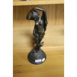 A BRONZE TYPE FIGURE OF A LADY WITH A CHERUB