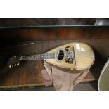 A VINTAGE MANDOLIN WITH TORTOISHELL AND MOTHER OF PEARL INLAY