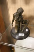 A BRONZE TYPE FIGURE OF A NUDE LADY WITH BADGE