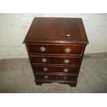 A REPRODUCTION MAHOGANY CHEST OF FOUR DRAWERS