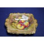 A HAND PAINTED FRUIT PATTERN DISH SIGNED R BUDD