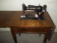 AN ANTIQUE SINGER SEWING TABLE