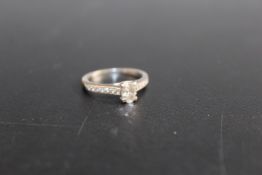 A HALLMARKED 18 CARAT WHITE GOLD OVAL DIAMOND SOLITAIRE RING, the central diamond being an