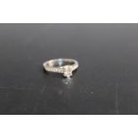 A HALLMARKED 18 CARAT WHITE GOLD OVAL DIAMOND SOLITAIRE RING, the central diamond being an