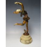 AN ART DECO STYLE BRONZED METAL FIGURE OF DANCER, with an ivorine face, hands and torso, supported