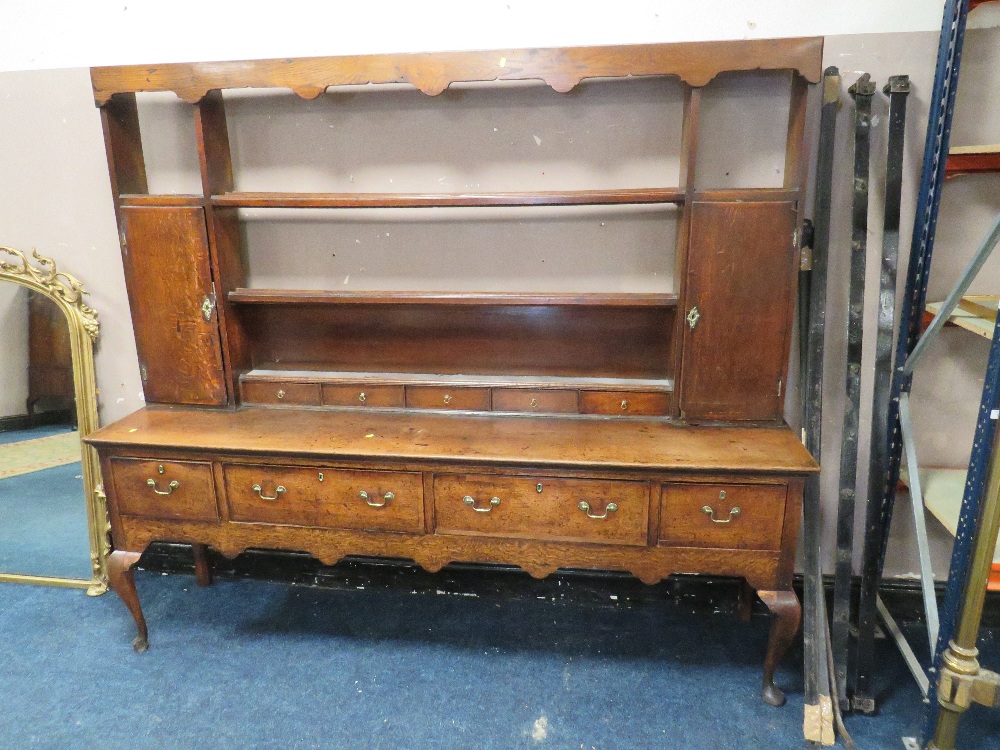 A 19TH CENTURY OAK DRESSER, the open plate rack with two cupboards and five spice drawers, the lower