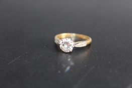 AN 18CT & PLAT DIAMOND SOLITAIRE RING, the solitaire being of an estimated 0.66 ct with a further