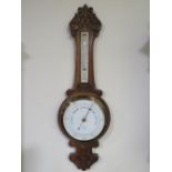 AN EARLY 20TH CENTURY CARVED OAK BAROMETER, by 'Ben Franks Ltd.', H 82 cm