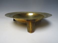 A BRASS ARTS AND CRAFTS FOOTED BOWL, modernist styling with all over hammered finish, central raised