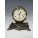 A VICTORIAN DRUM HEAD MANTEL CLOCK, the circular dial raised on a cherubic stand, H 15.5 cm S/D
