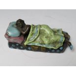 A VINTAGE COLD PAINTED BRONZE FIGURE DEPICTING A NAKED FEMALE UNDER A LOOSE COVER, bearing stamp