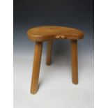 A ROBERT MOUSEMAN THOMPSON THREE LEGGED STOOL, with typical carved mouse to front lip, H 36 cm
