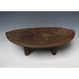 A POLYNESIAN STYLE KAVA BOWL, raised on four tapered feet, W 46 cm