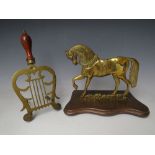 A VICTORIAN BRASS HORSE HEARTH ORNAMENT, H 22 cm, together with a brass Lyre shaped trivet (2)