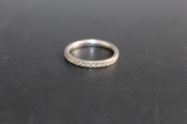 A DIAMOND HALF ETERNITY RING, set with fifteen accent diamonds in unmarked white metal, approx